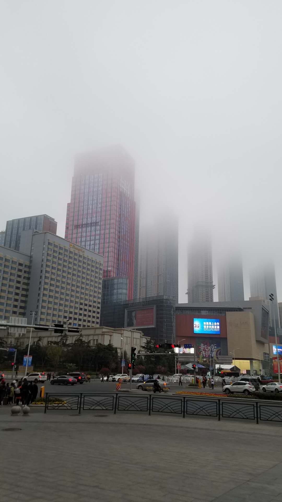 skyscrapers rising into fog